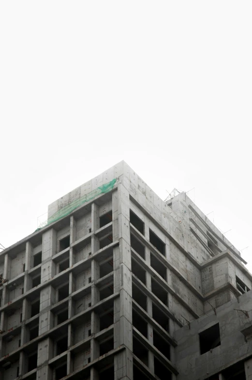 the top of a tall concrete building is viewed