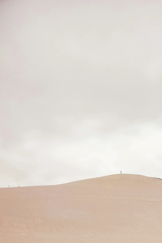 a person that is walking through the sand