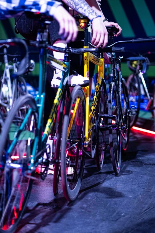 men riding bicycles on a track at night