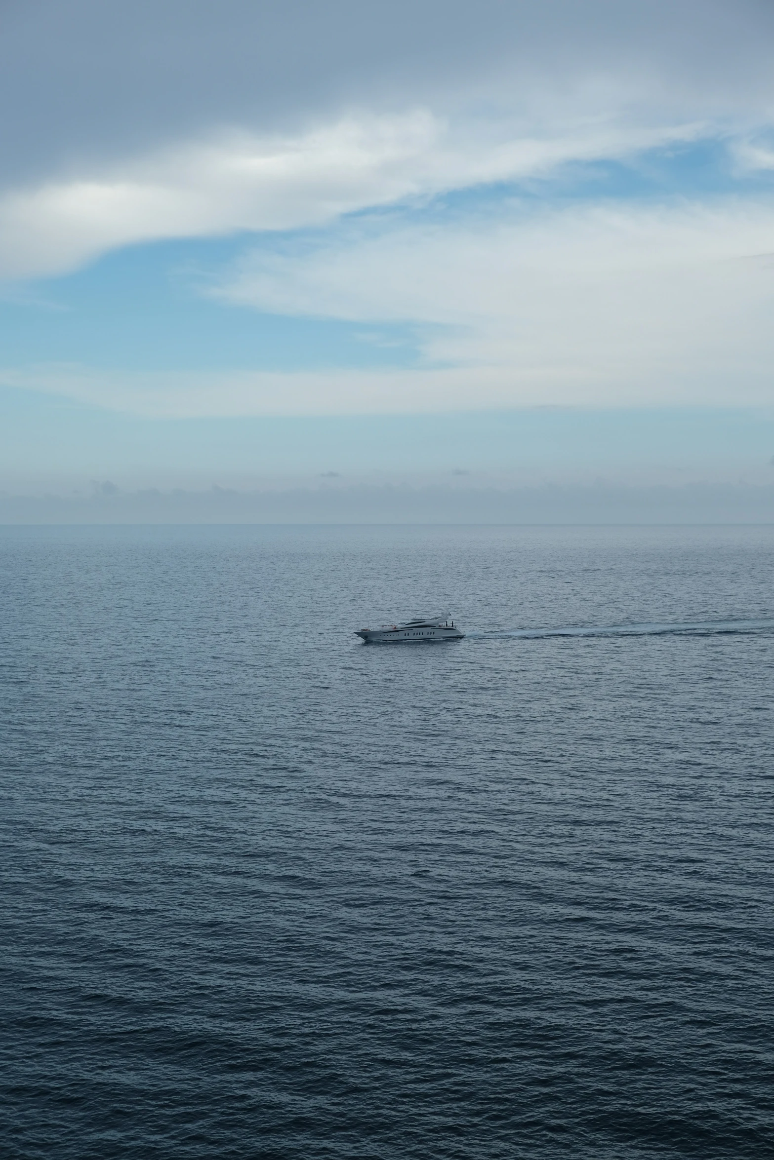 a boat floating in the middle of the ocean