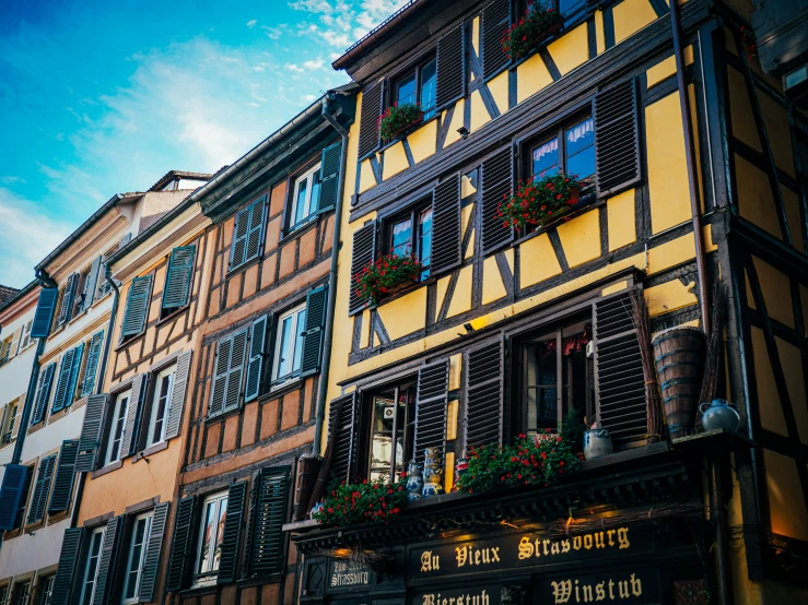 an old european building with open windows on it