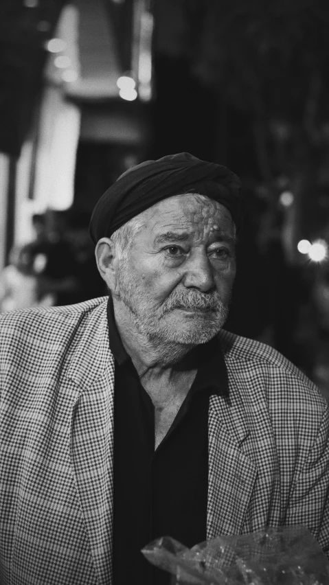 a man is posing for a picture while sitting at a table