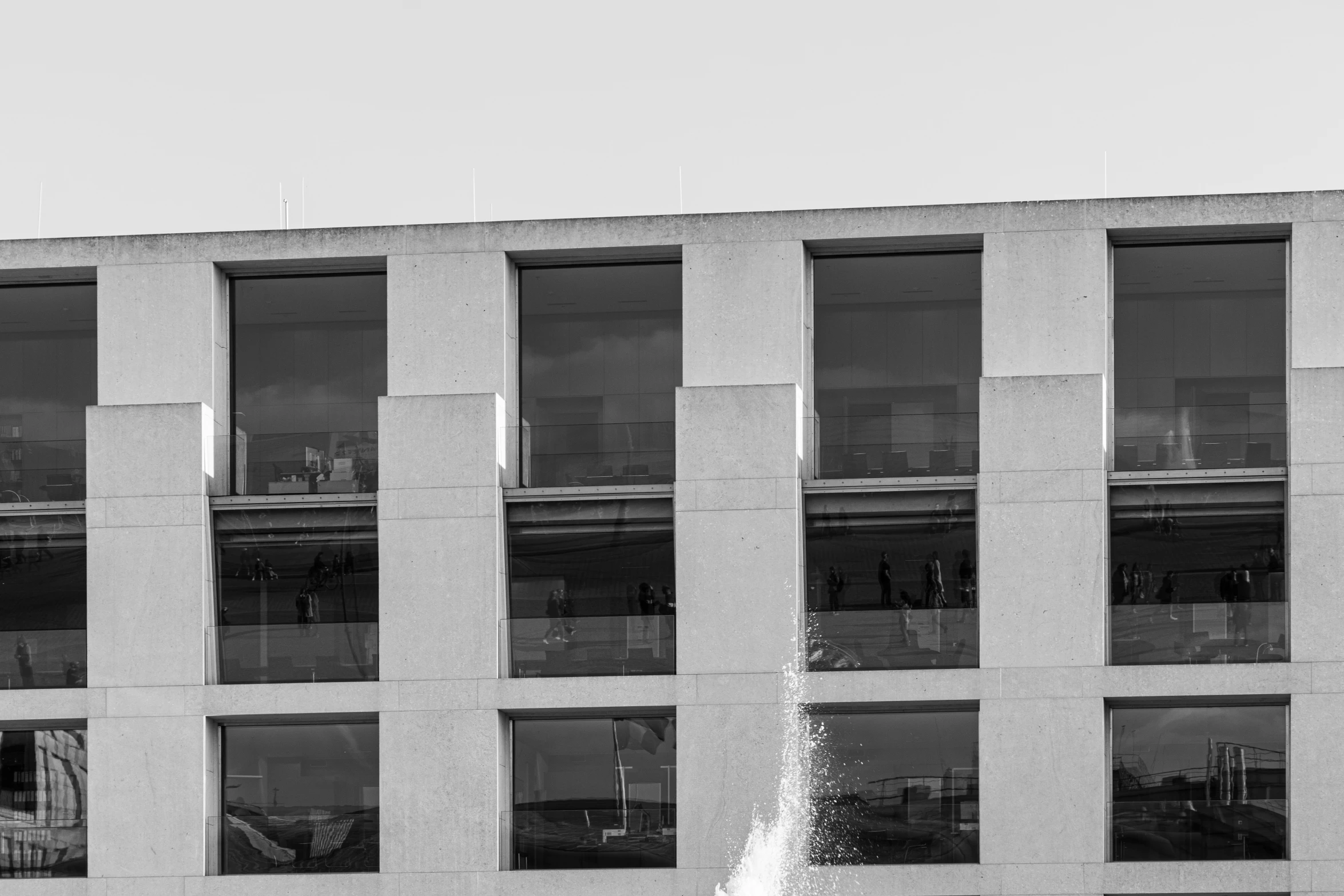 the side of a building with the water spray running off it