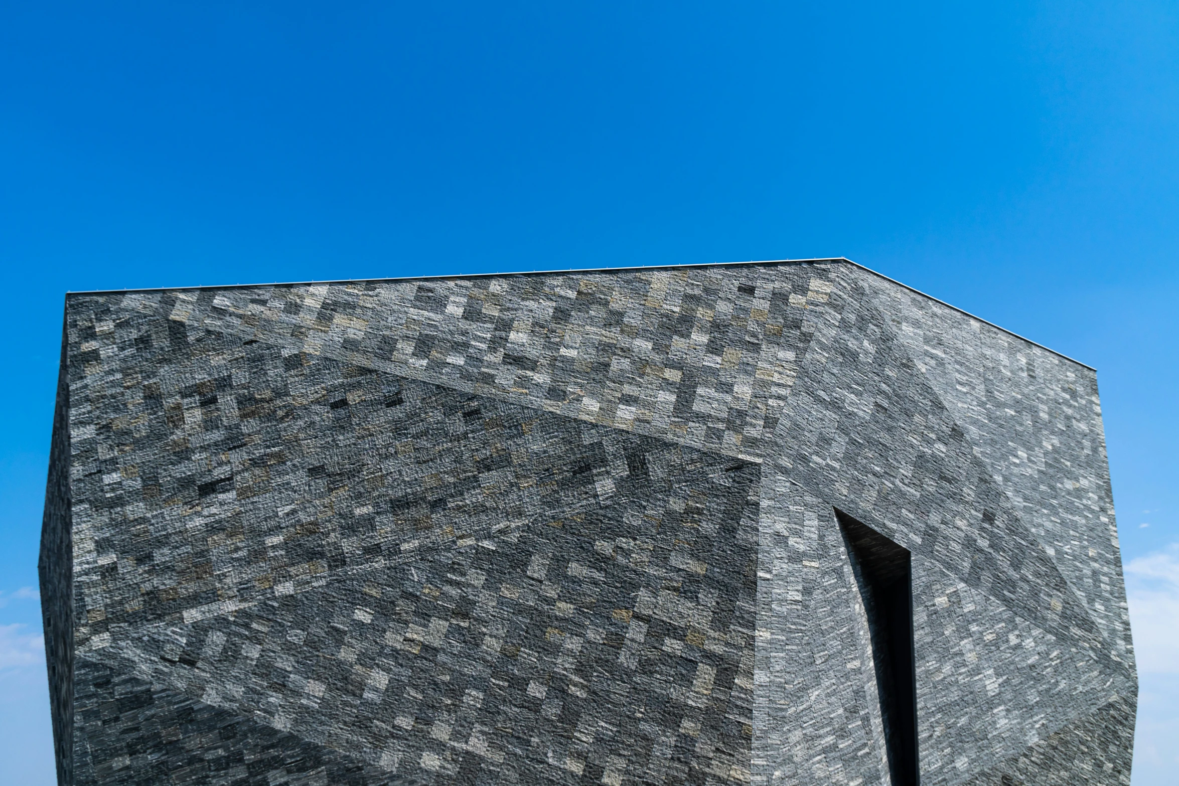 the corner of a building with a sky in the background