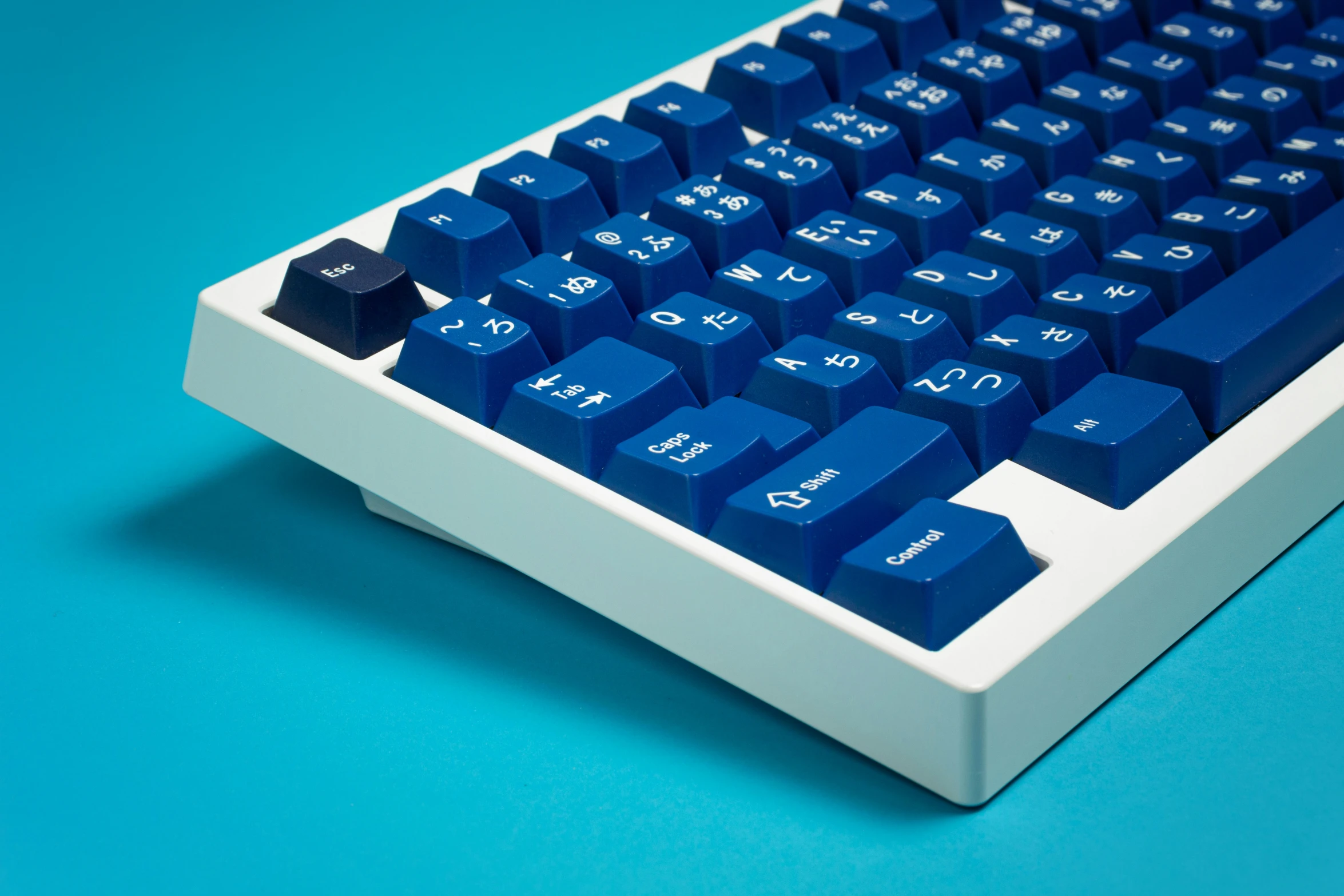 the blue computer keyboard is on a blue background