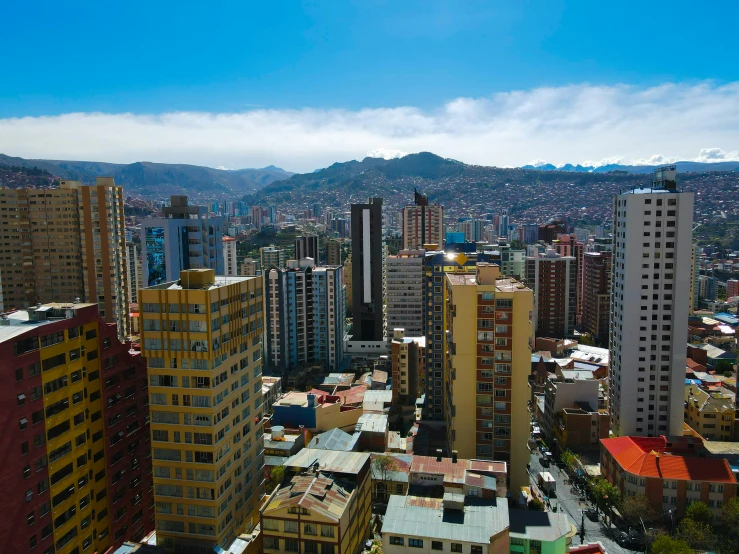 a large city with many buildings under a cloudy blue sky