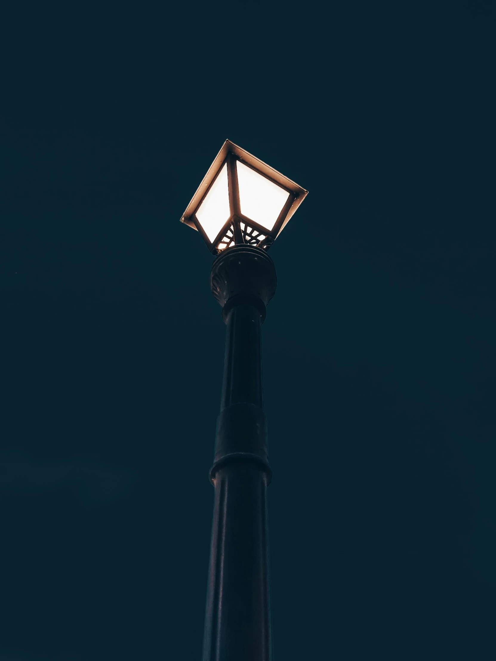 a lit street light on the side of a building
