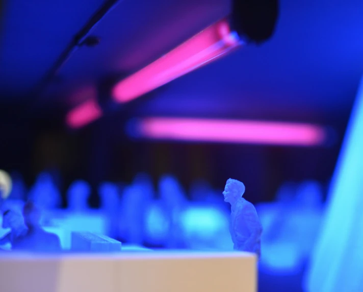 a person sitting on a stage at a conference