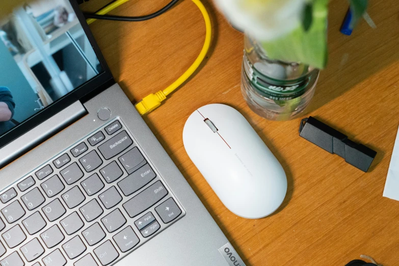 the desk is cluttered with several items and a laptop computer