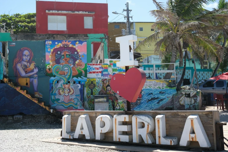 colorful building behind a colorful sign that says laperlia