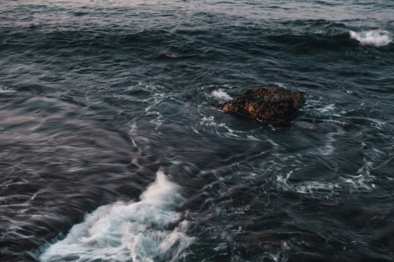 a rock is on the bottom of some water