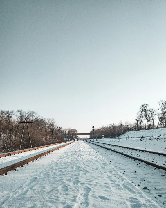 a train track with snow on the tracks