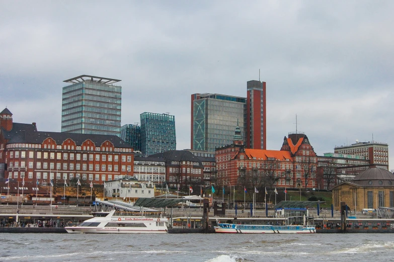 a large building is beside a harbor with boats