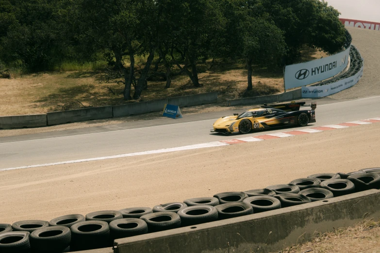 a car racing down a racing track next to tires