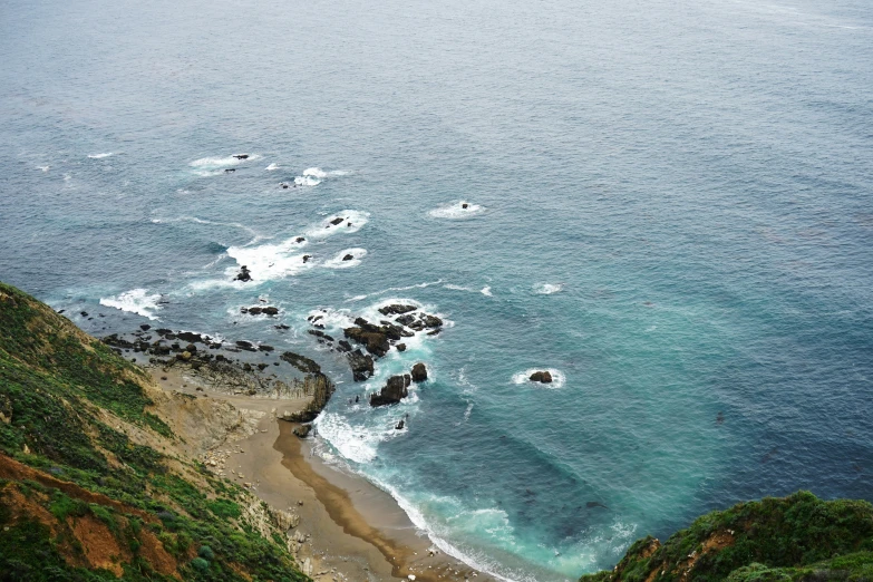 the ocean is crystal blue and green with some white dots