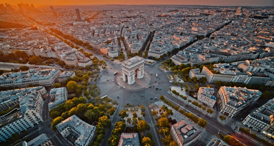 an aerial view of the city of paris at sunset