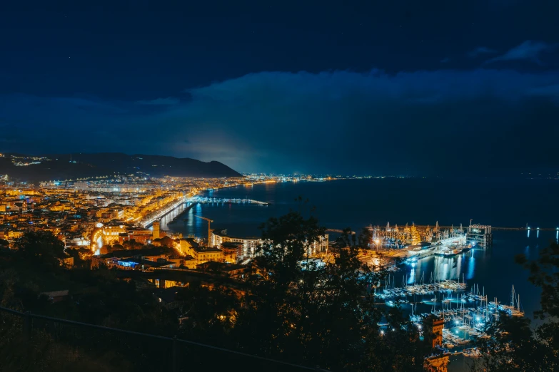 the city lights at night by the ocean