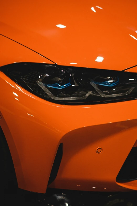 a close up s of a shiny orange car hood