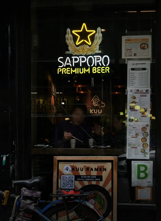 an advertit on the glass windows of a bar