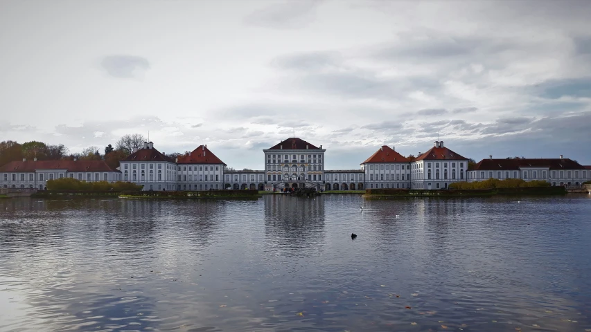 a castle on top of the lake surrounded by a forest