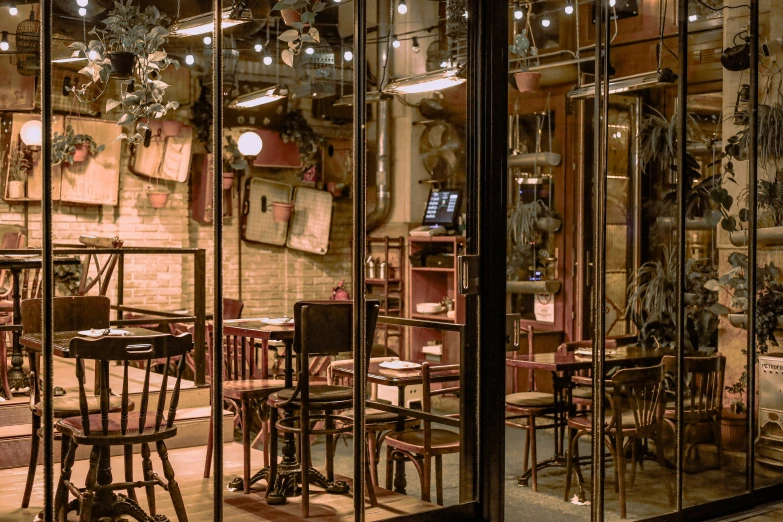 an antique shopfront is lit up with lights and wood chairs