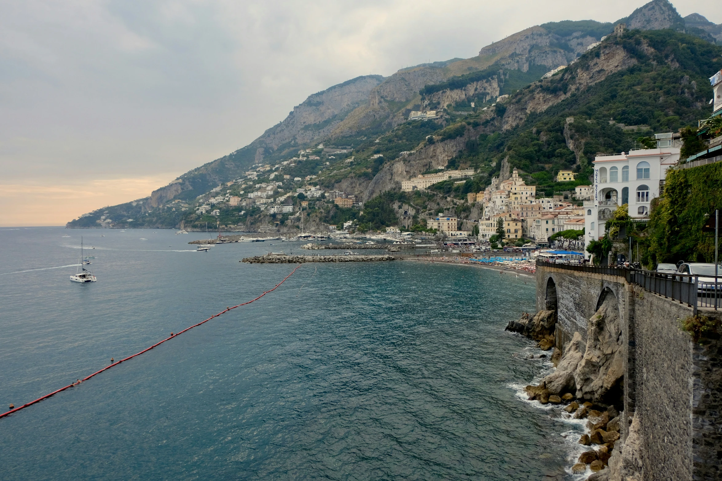 the coast line in ravella, italy with a small fishing boat near it