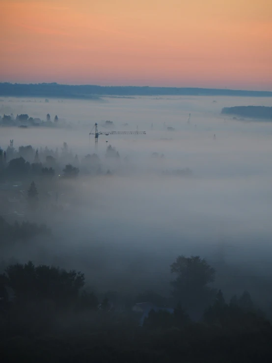 fog moves across the valleys below a sunrise sky