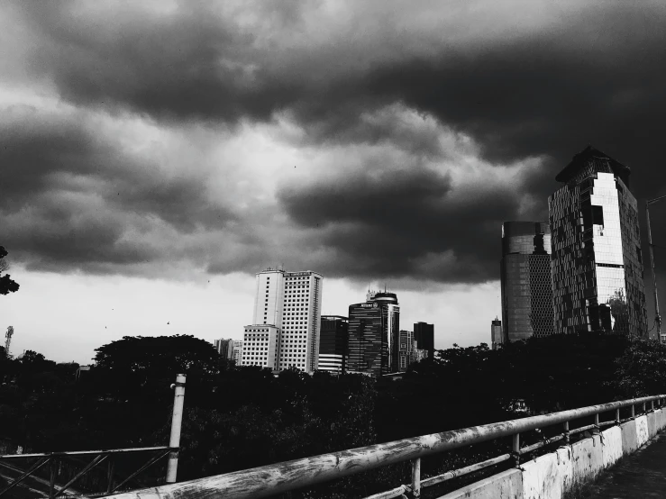 the buildings have dark clouds in the background