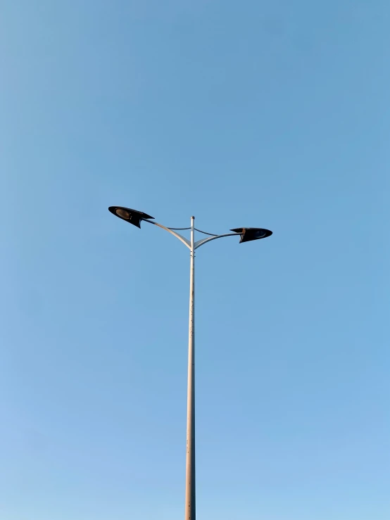 a street light stands alone on a clear day