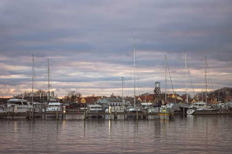 boats are docked at the end of the pier