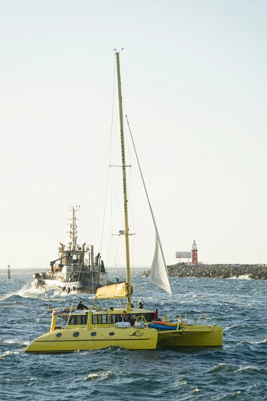 a small yellow boat and a yellow boat are in the water