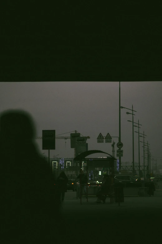 the silhouette of two people walking in front of an intersection