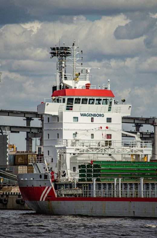 a large boat in the water near a dock