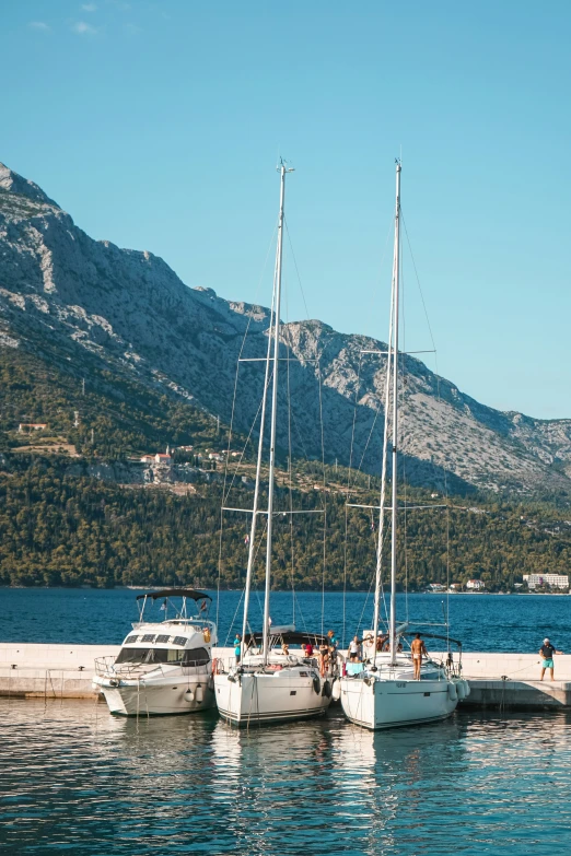 a couple of sailboats are sitting in the water