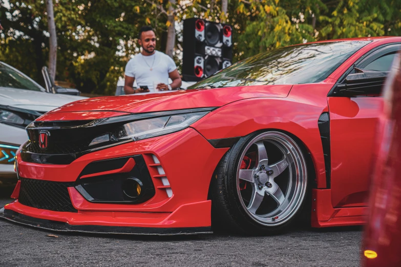 the red sports car is parked on the street