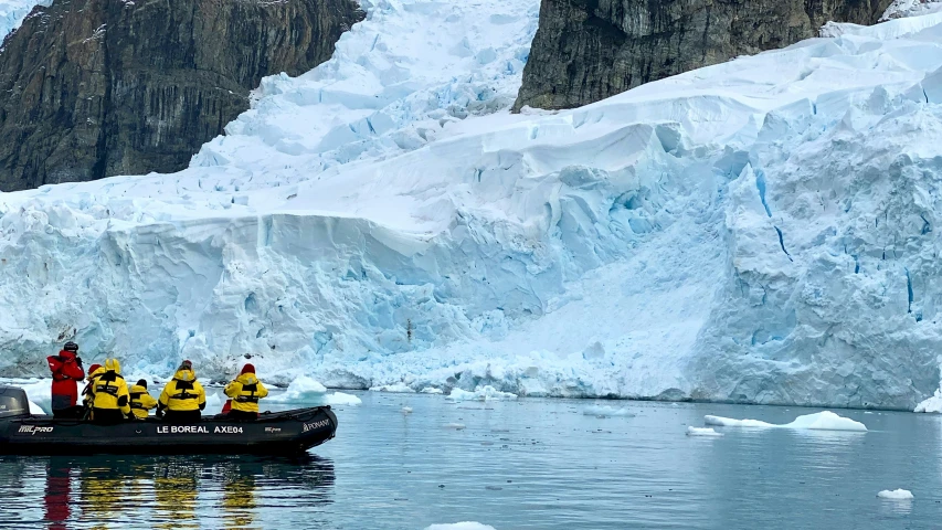 some people in yellow jackets and a raft are going through the water