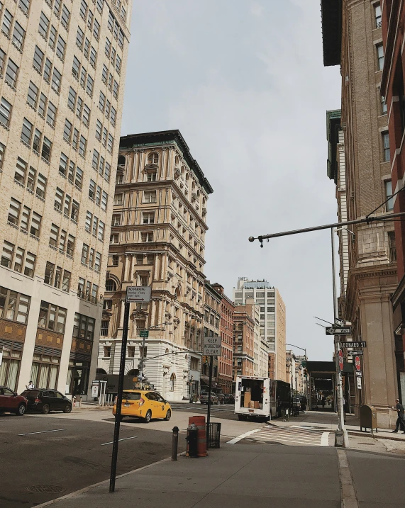 a bus driving past tall buildings in an empty city