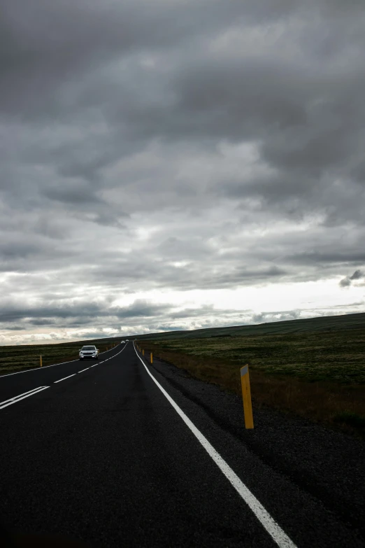 a road with an overcast sky above