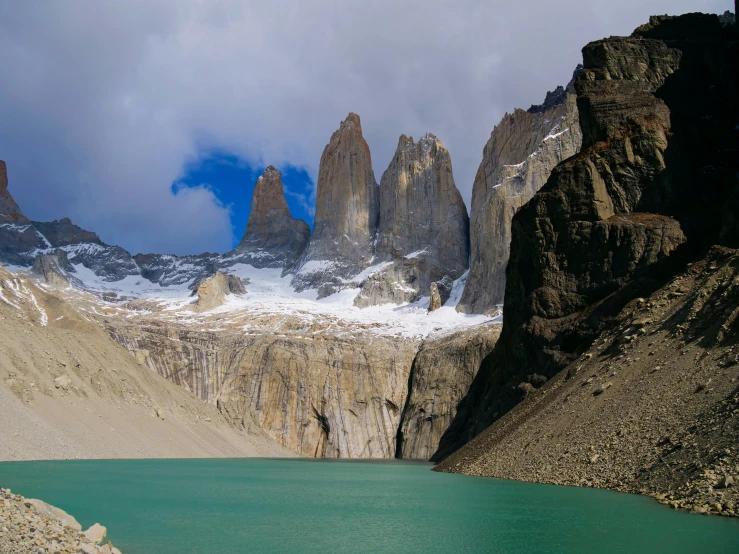 a mountain and lake near the top of some high mountains