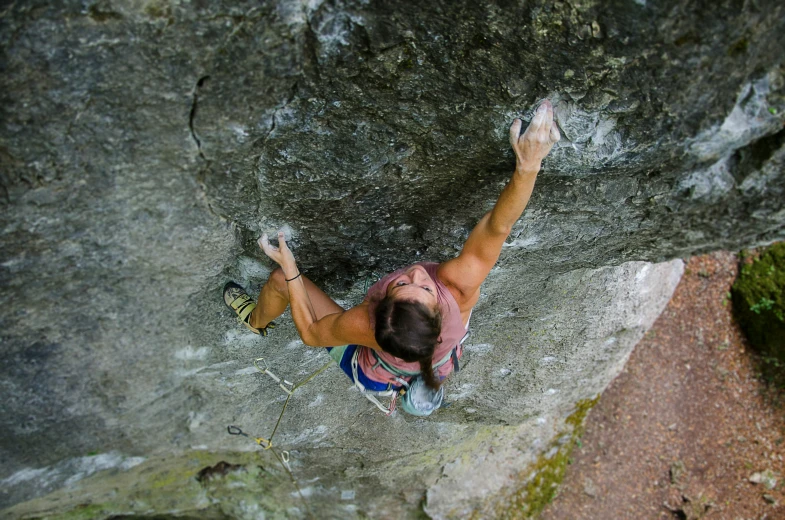 man climbing on rock with  on