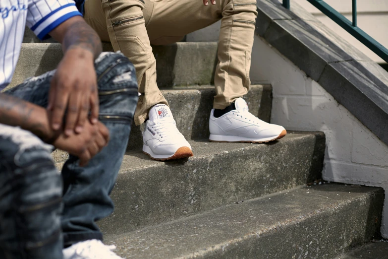 two people that are sitting down on some stairs