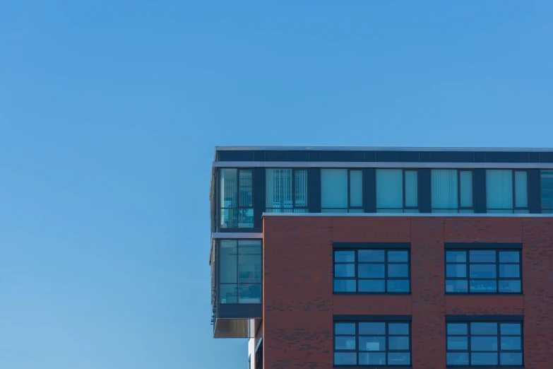 the building with several windows is next to a clock