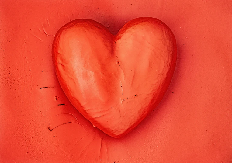 a red heart shape on the corner of a wall