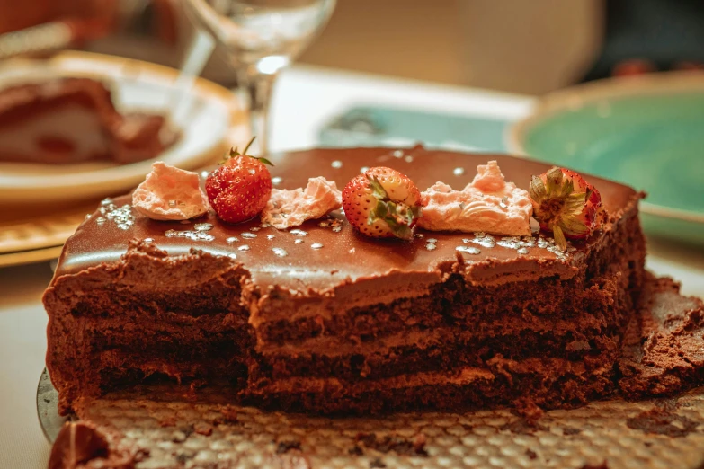 chocolate cake with slices removed and covered in strawberry filling