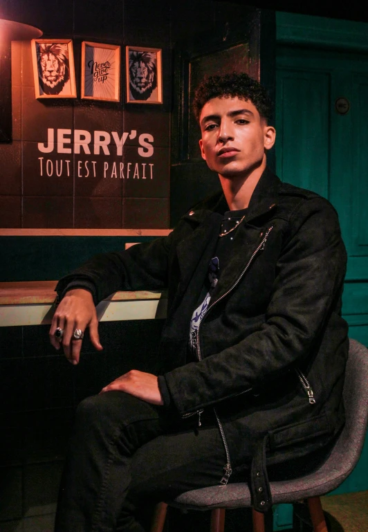 a young man sitting at a bar