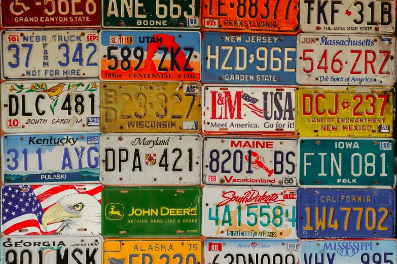 a number of license plates stacked on top of one another