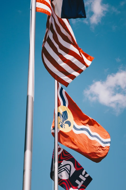 three american flags are flying in the sky