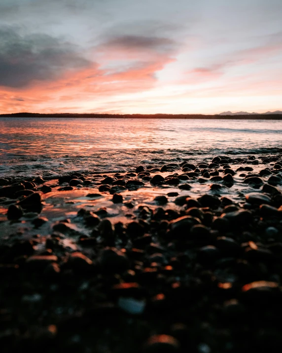 sunrise at the beach showing rocks in water