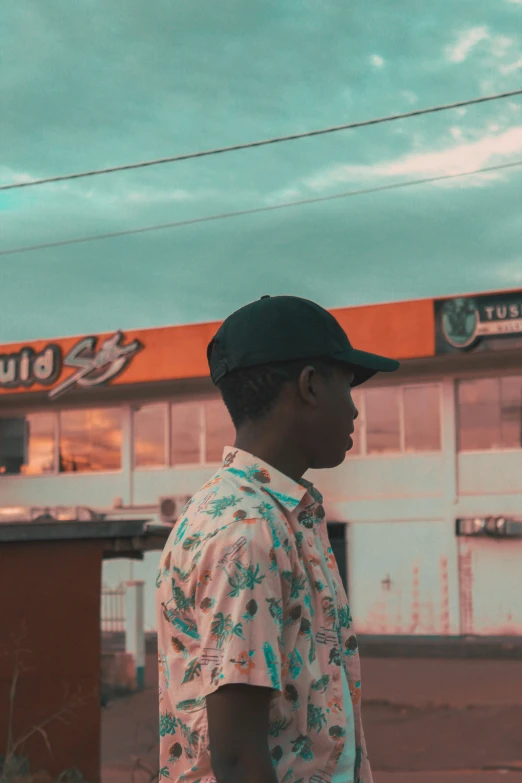 a man with a hat standing outside a store