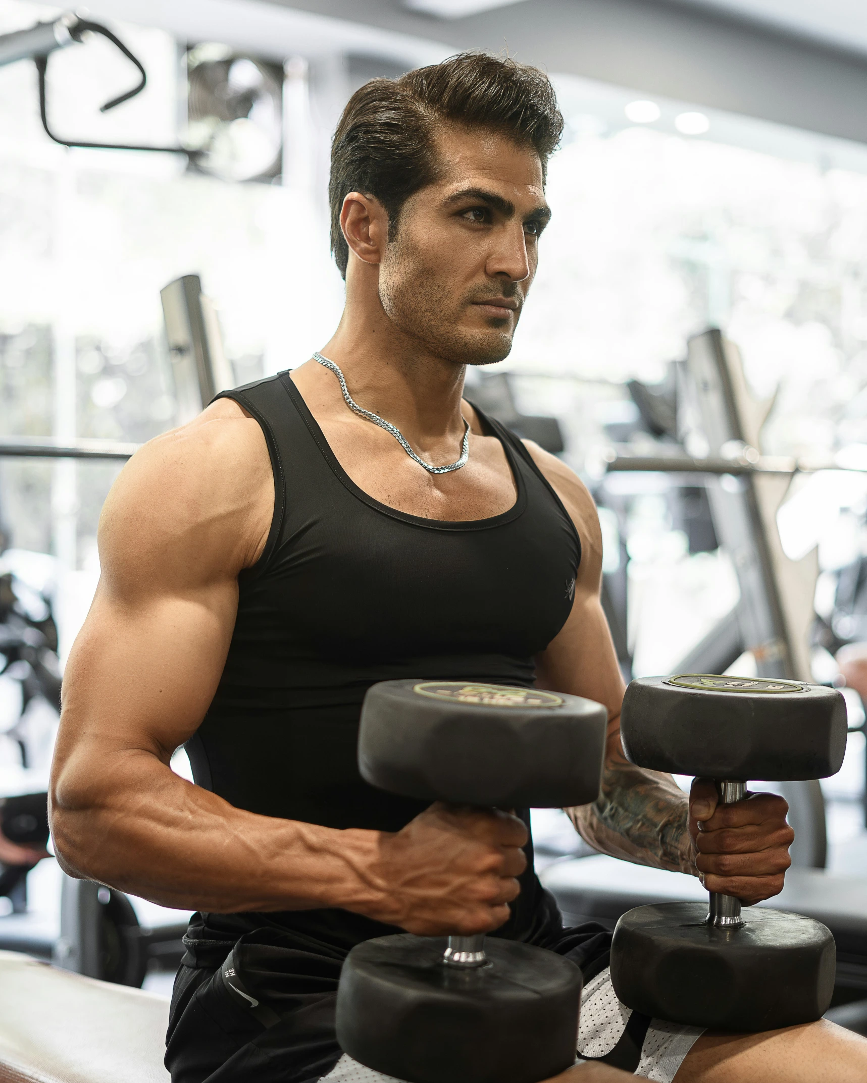 a man with muscular arms in the gym